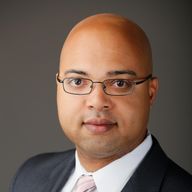 Erik Caldwell, studio headshot, dark suit and tie